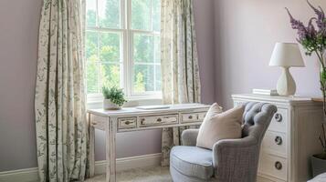 A calming study space with muted lavender walls a distressed white desk and a cozy grey armchair adorned with muted green and cream patterned curtains photo