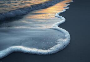 A Soft Wave Gently Lapping on the Sandy Shore at Sunset photo