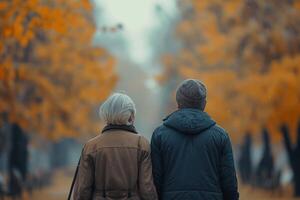 Elderly couple, united by love and warmth, walks along the autumn streets in stylish outerwear photo