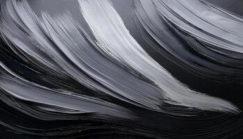 Close-up of bold black and white paintbrush strokes on canvas, creating a textured abstract pattern with flowing motion. photo