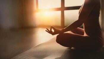 Close-up of a woman practicing meditation indoors, sitting cross-legged with hands in a mudra, illuminated by warm morning sunlight. photo
