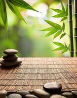 Zen-inspired setup with bamboo stalks, smooth stones, and a woven mat, creating a peaceful and natural environment for relaxation. photo
