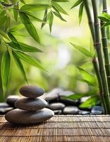 A stack of smooth stones on a bamboo mat surrounded by lush green bamboo leaves, evoking a serene and meditative atmosphere. photo