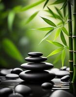 Zen arrangement of smooth black stones stacked in water, surrounded by bamboo leaves, creating a serene and meditative ambiance. photo