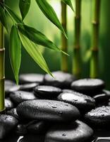 Smooth black spa stones covered in water droplets, surrounded by fresh green bamboo leaves, creating a serene and refreshing ambiance. photo