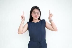 Beautiful Asian Woman wearing formal dress Showing Product and Pointing Up Isolated On White Background photo