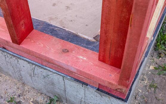 The image shows a close-up view of the wooden beams of a roof structure under construction. The image conveys a sense of progress and anticipation, suggesting that the house is nearing completion. photo