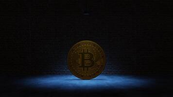 Golden Bitcoin under a blue spotlight in front of a brick wall photo