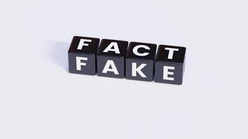Black, White Fact and Fake - Word On Plastic Blocks - With White Background photo