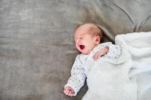 Close-up portrait of adorable baby boy sleeping in bed, 1 year old baby concept photo