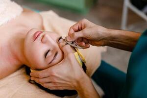 Facial massage with gouache stone in a beauty salon photo