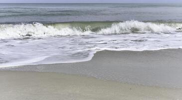 White soft Seawave surf on the beach, photo