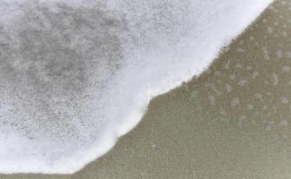 White soft Seawave surf on the beach, photo