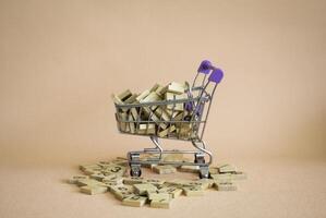 Shopping cart and numberic wood block put on background. photo