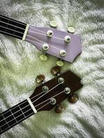 Two pieces of Ukulele headstock with tuning pegs made from wood,use for set up sound, photo