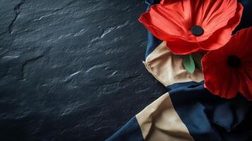 Red Poppy Flowers on Dark Slate Background with Navy and Beige Fabric photo
