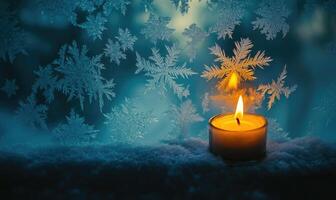 A candle is lit on a snowy surface photo
