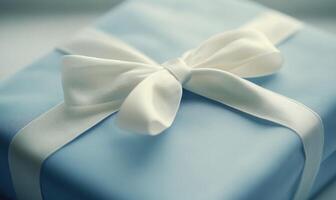 A blue box with a white bow on top of it photo