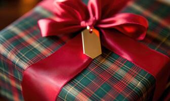 A green and red plaid box with a red ribbon and a gold tag photo