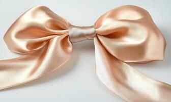 A peach satin bow on a white background photo