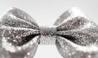 A silver bow with glitter on it photo