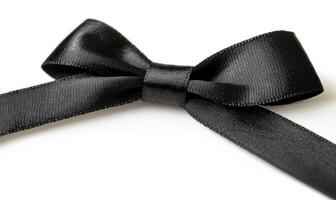 A black ribbon is tied into a bow photo
