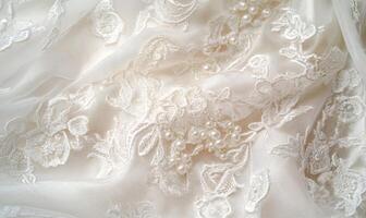 A close up of a white lace fabric with a floral pattern and pearls photo