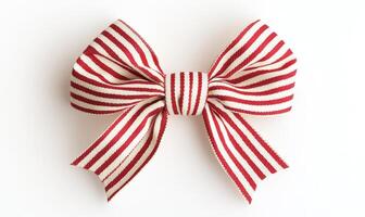 A red and white ribbon bow is sitting on a white background photo