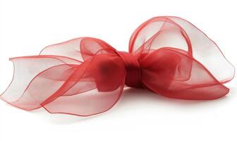 A red ribbon with a bow is laying on a white background photo