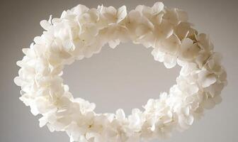 A white flower wreath with a white flower in the center photo