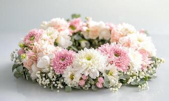 A flower arrangement with pink and white flowers in a round shape photo
