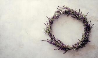 A purple wreath of lavender flowers sits on a white background photo