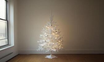 A white Christmas tree is lit up and standing in front of a window photo