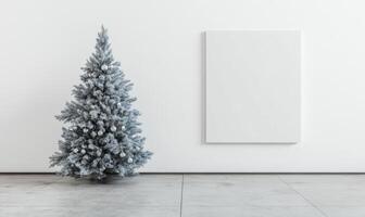 A white Christmas tree stands in front of a blank wall photo