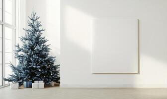 A white wall with a blue Christmas tree in front of it photo
