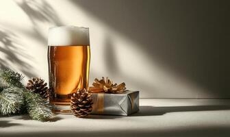A glass of beer is on a table with a box of presents and pine cones photo