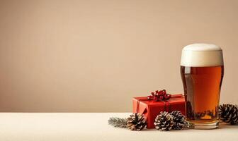 A glass of beer sits on a table next to a red box with a ribbon on it photo