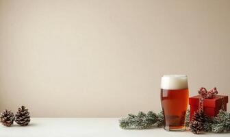 A glass of beer sits on a table next to a red box and pine cones photo