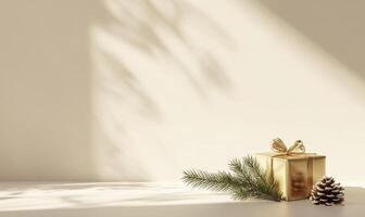 A gold box with a bow sits on a table next to a pine cone photo
