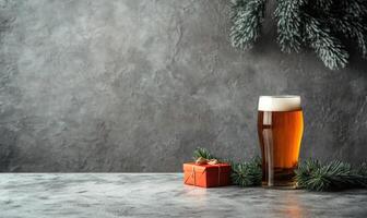 A glass of beer sits on a table next to a red box photo