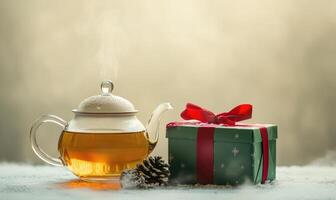 A teapot with steam coming out of it sits next to a green box with a red ribbon photo