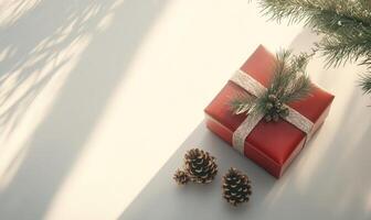 A red box with a ribbon on top sits on a white background photo