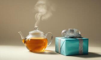 A teapot with steam coming out of it sits next to a blue box photo