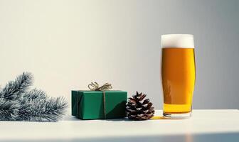 A green box with a ribbon sits on a table next to a glass of beer photo