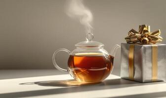 A tea pot with steam coming out of it sits on a table next to a silver box photo
