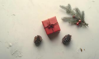 A red box with a bow on top sits on a white background photo