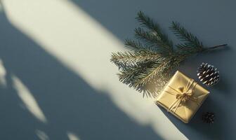 A gold box with a pine tree branch and pine cones on top of it photo