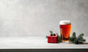 A glass of beer sits on a table next to a red box photo
