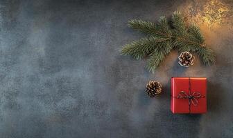 A red box with a ribbon on it sits on a grey background photo