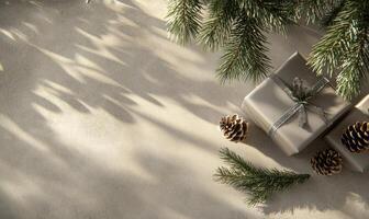 A box with a ribbon sits on a table next to pine cones photo